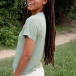 Side view of a female model wearing the Women's Crew Neck Tee in Thyme