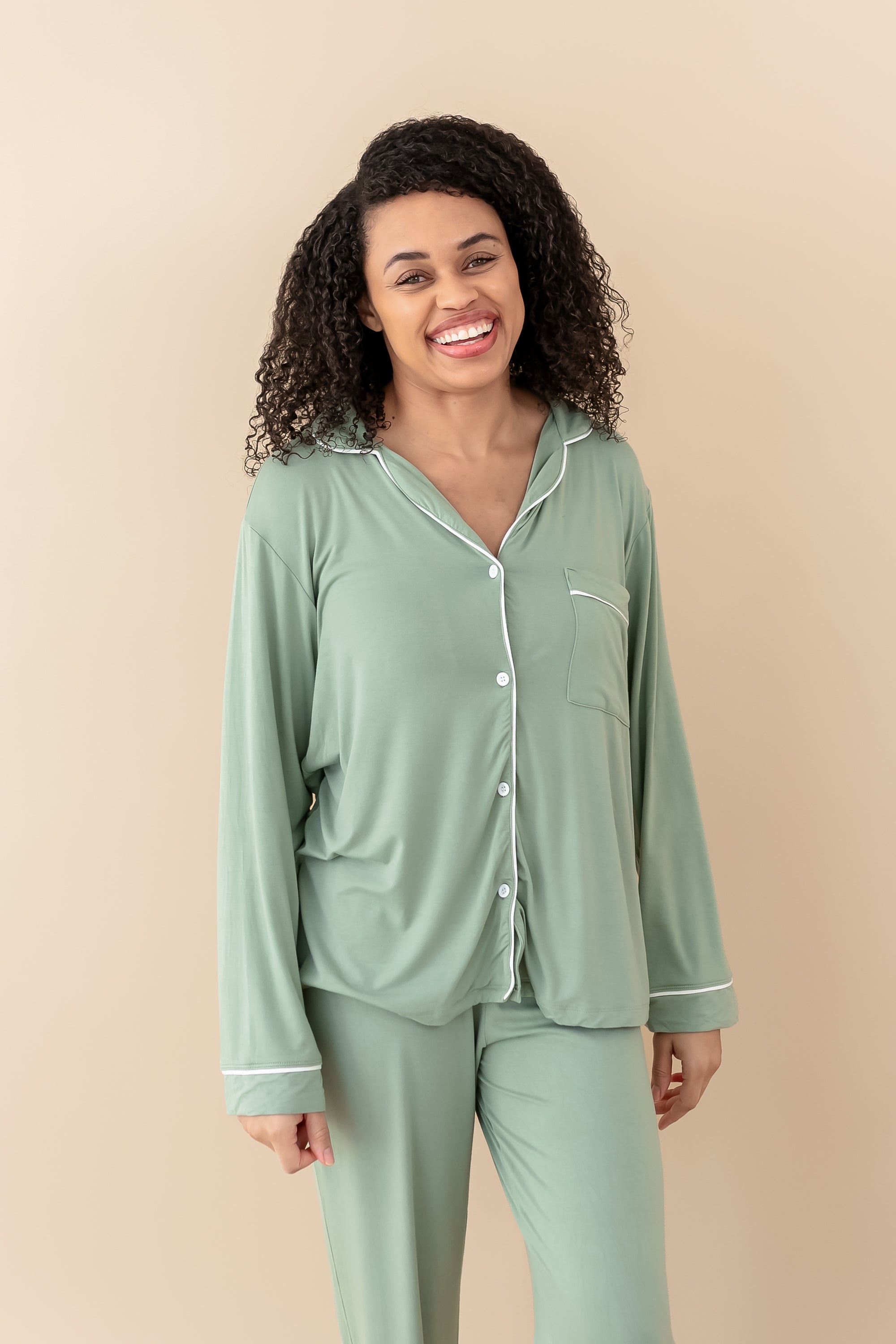Model wearing Kyte Baby's Women's Long Sleeve Pajama Set in Thyme with Cloud Trim