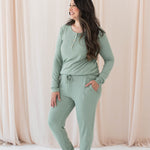 Model wearing the Women's Ribbed Jogger Pant in Thyme with one hand in pants pocket