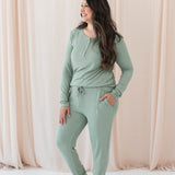 Model wearing the Women's Ribbed Jogger Pant in Thyme with one hand in pants pocket