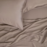 Close up of the Bamboo Sateen Sheet Set in Truffle shown on a bed