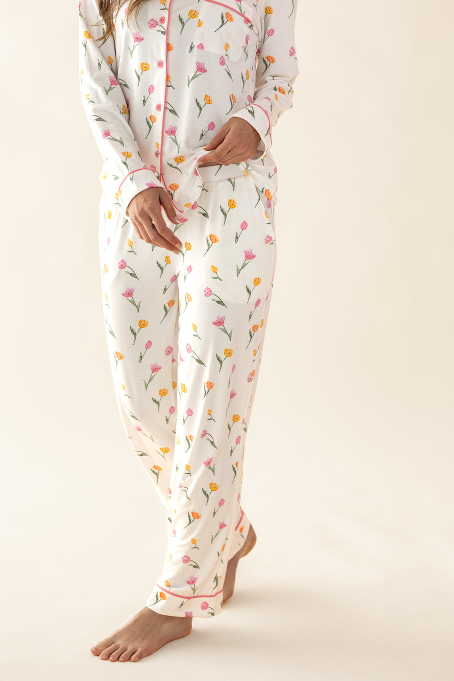 Person wearing a floral pajama set on a plain background