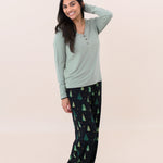Smiling model with hand in hair while wearing the Women's Lounge Pants in Twinkle Tree