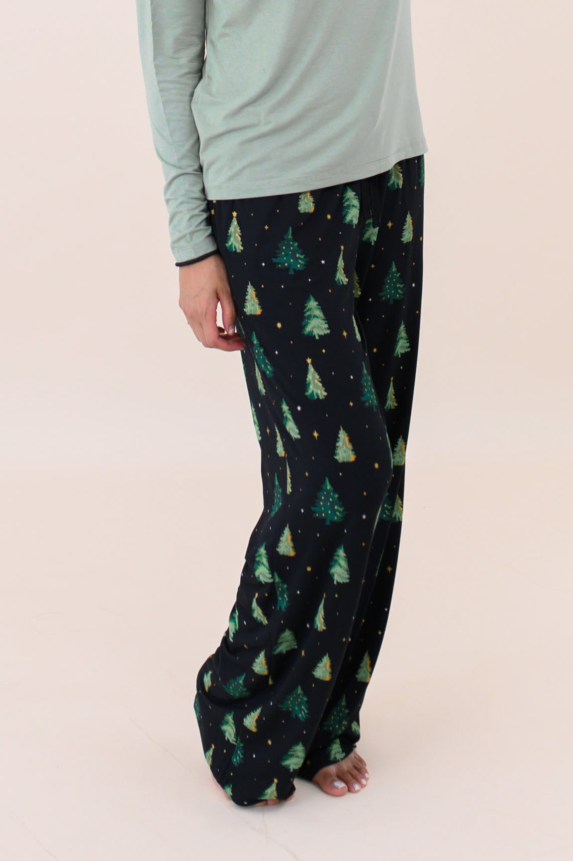 Smiling model with hand in hair while wearing the Women's Lounge Pants in Twinkle Tree