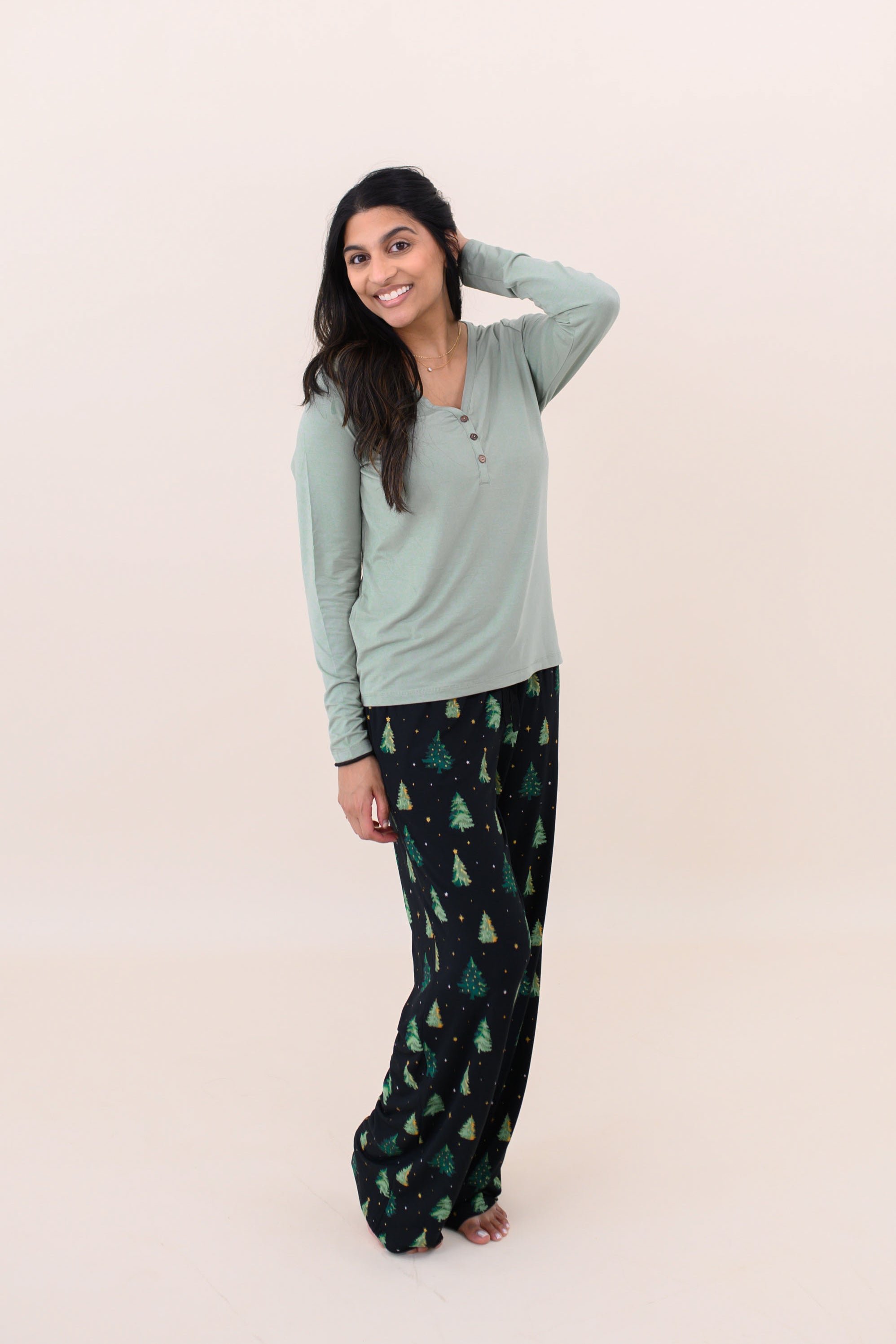 Smiling model with hand in hair while wearing the Women's Lounge Pants in Twinkle Tree