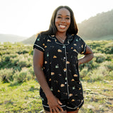 Woman modeling Women's Short Sleeve Pajama Set in Under the Stars with hand on hip in Yellowstone National Park