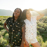 2 women modeling Kyte Living x National Park Foundation collaboration prints. Under the Stars and Road Trip in the Short Sleeve Pajama style.