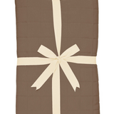 Medium brown quilted throw blanket folded and tied with a ribbon