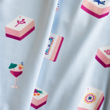 close up of fabric in light blue color with a pattern of pink mahjong