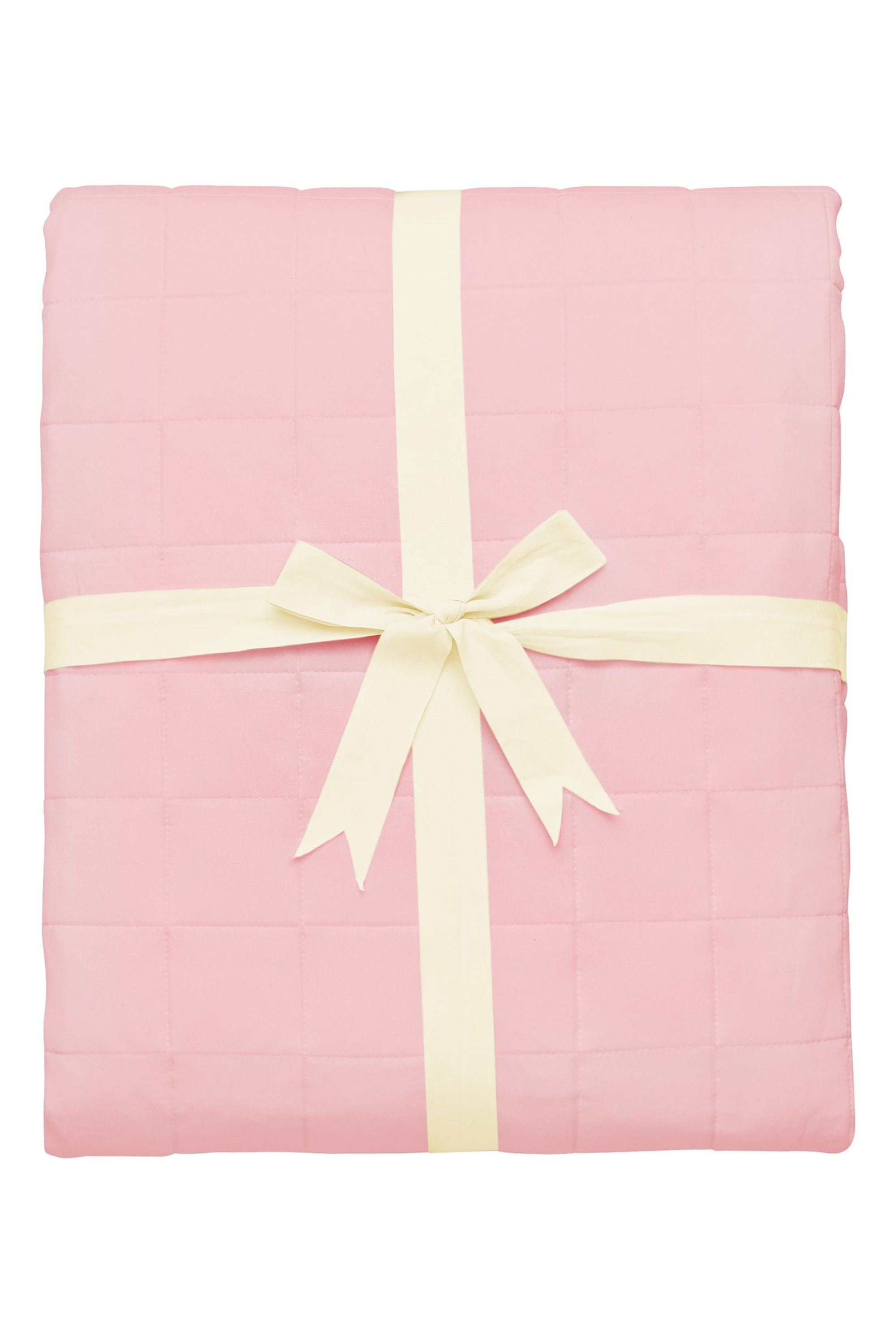 Pink quilted blanket folded and tied with ribbon
