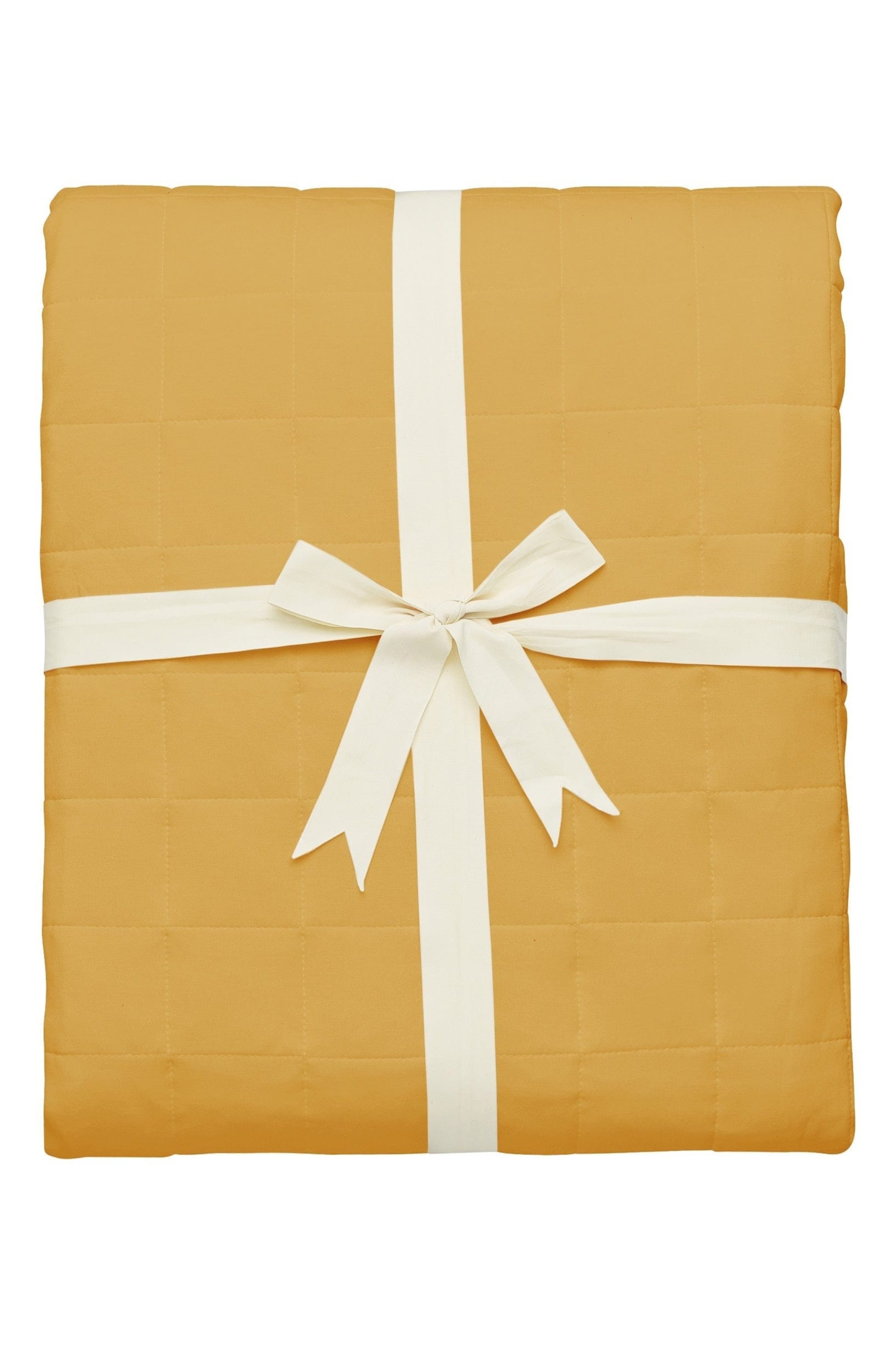 Quilted bamboo blanket in a Marigold yellow folded and tied with ribbon