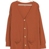 Rust color bamboo cardigan hanging on hanger