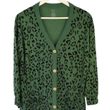 Green bamboo cardigan with leopard print hanging on a hanger 