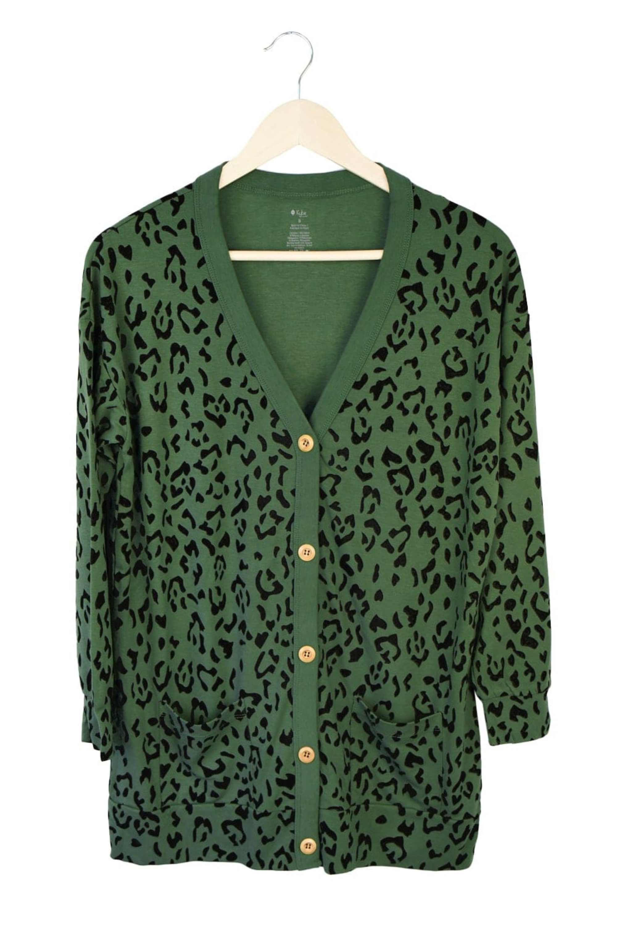 Green bamboo cardigan with leopard print hanging on a hanger 