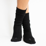 Woman modeling black scrunch socks against white backdrop
