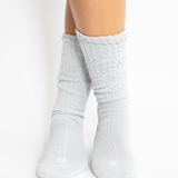 light grey socks worn by a person on a white background