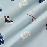 A repeating, all-over print featuring a dark blue hockey jersey with the numbers 00, a pair of crossed brown hockey sticks with a black hockey puck, a white hockey goal, and a pair of black hockey skates, over a light dusty blue background
