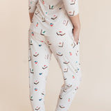 Model showcasing backside of Women's Jogger Pajama Set in Vanilla Mahjong print on a beige background