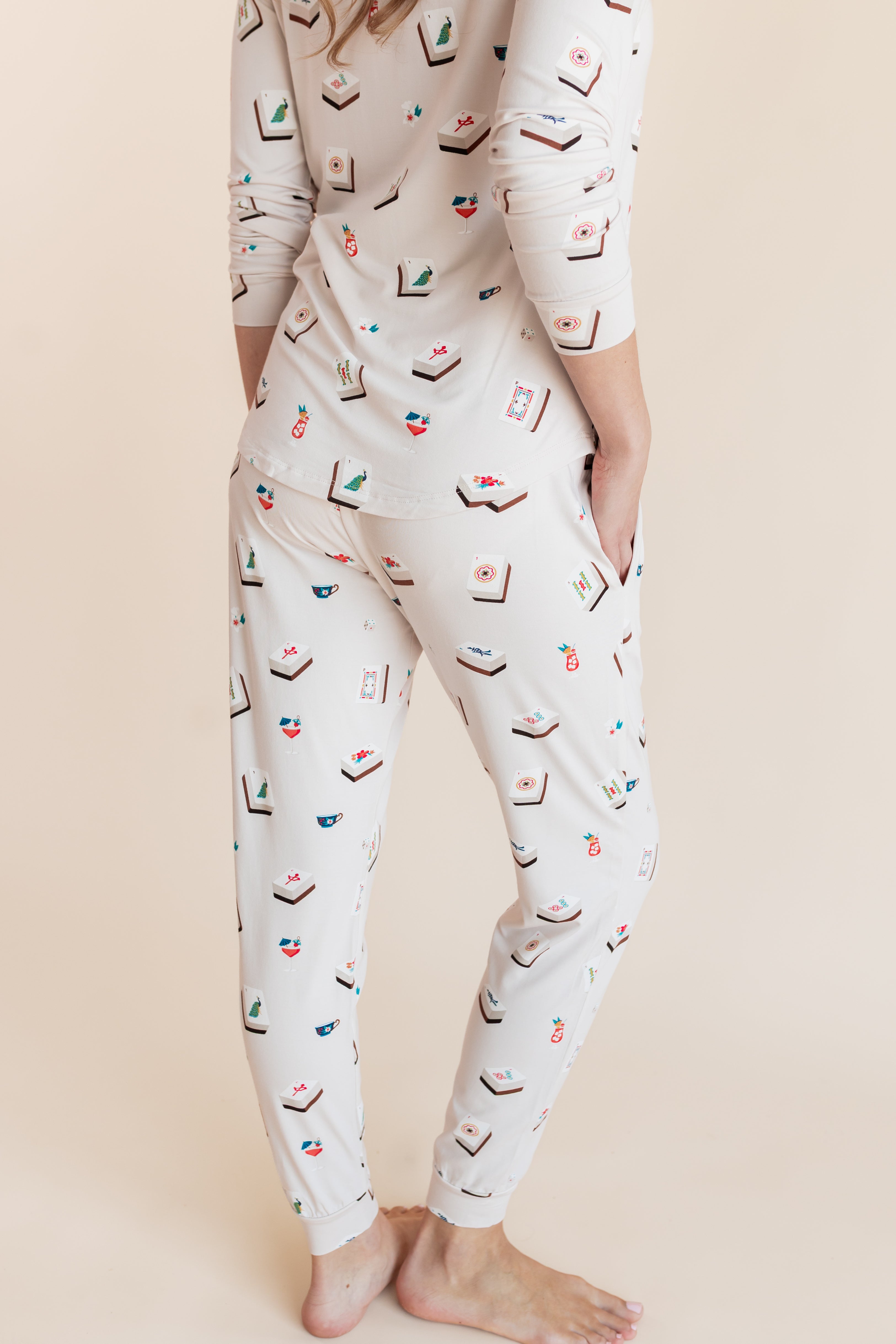 Model showcasing backside of Women's Jogger Pajama Set in Vanilla Mahjong print on a beige background