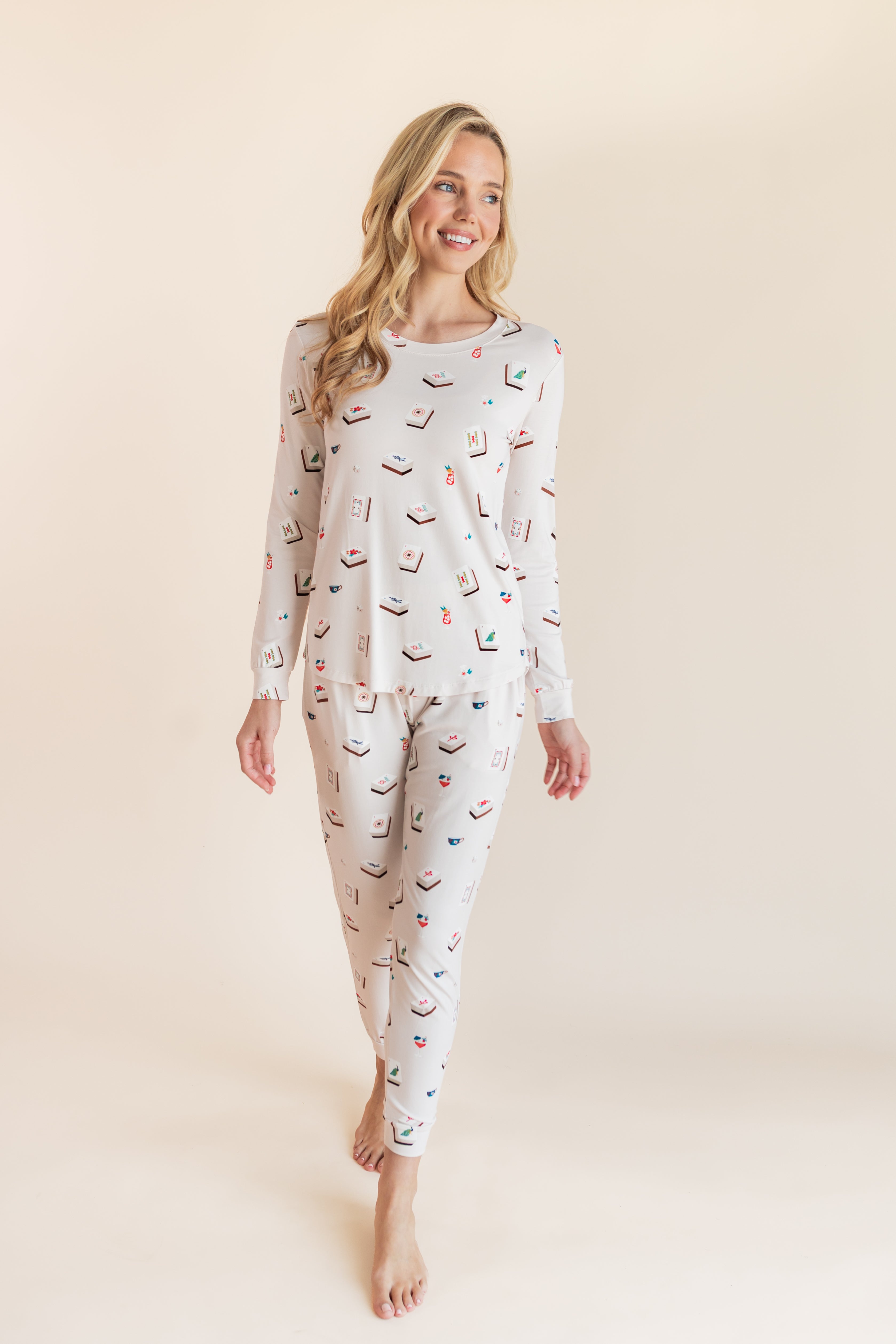 Model posing in Women's Jogger Pajama Set in Vanilla Mahjong print on a beige background
