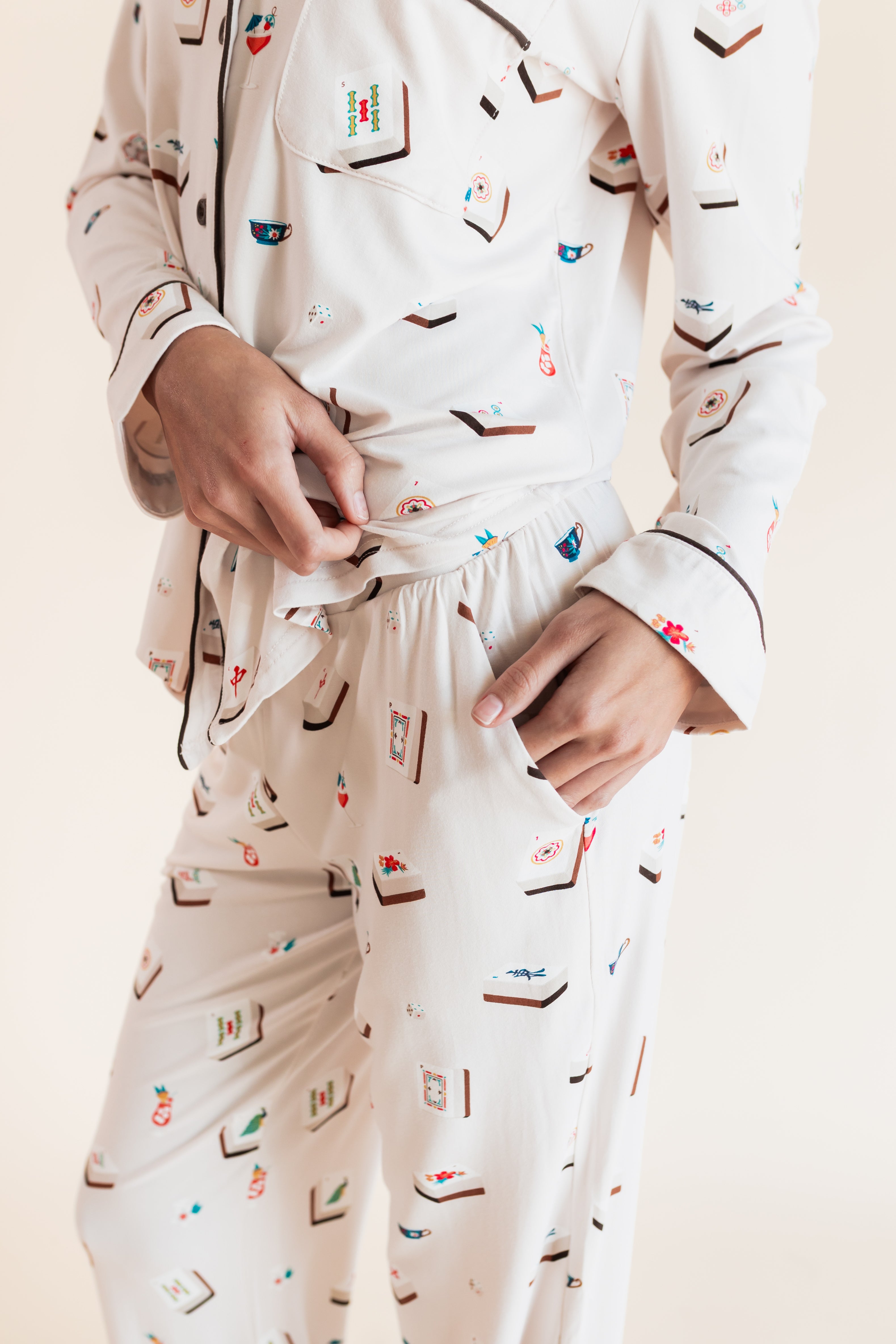 Model showcasing pockets on Long-Sleeved Women's Pajama Set in Vanilla Mahjong print on a beige background
---1605 1