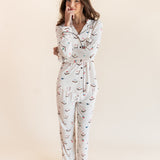 Model posing in Long-Sleeved Women's Pajama Set in Vanilla Mahjong print with brown trim on a beige background
---1605 3
