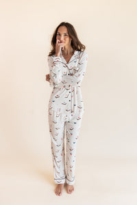 Model posing in Long-Sleeved Women's Pajama Set in Vanilla Mahjong print with brown trim on a beige background
---1605 3