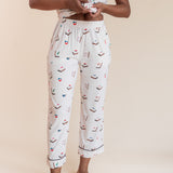 Close up of Model wearing Women's Short Sleeve Cropped Pajama Set in Vanilla Mahjong print on a beige background
---1620 3