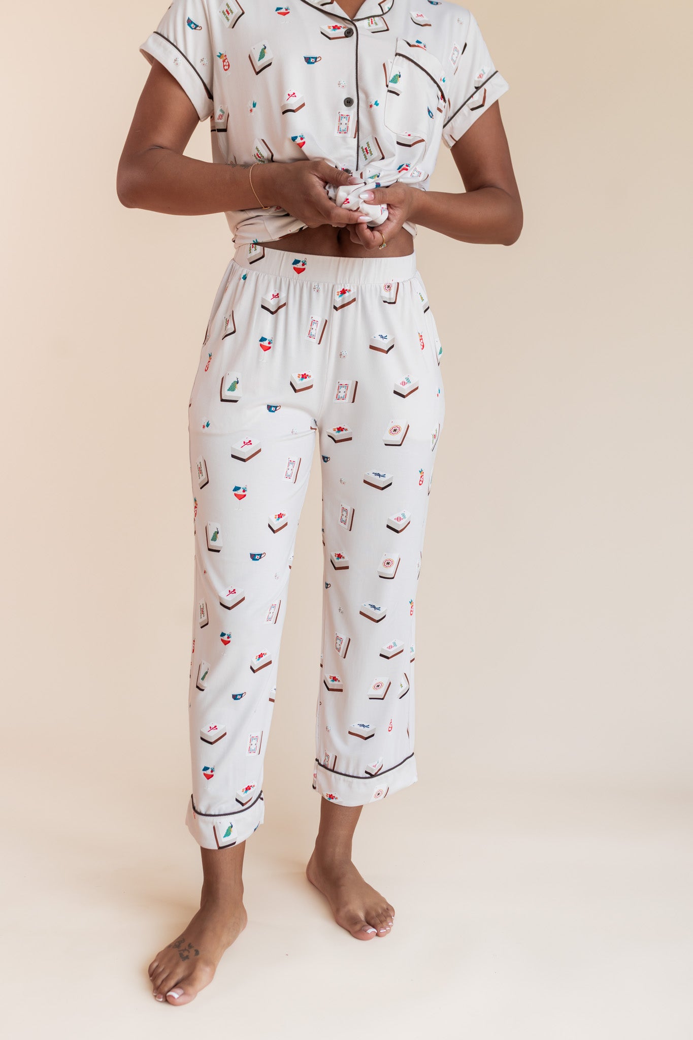 Close up of Model wearing Women's Short Sleeve Cropped Pajama Set in Vanilla Mahjong print on a beige background
---1620 3