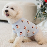 Small white dog sitting on a cream carpet wearing the Dog Tee in Vintage Santa in front of a decorated christmas tree