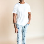 Man posing in Men's Lounge Pants in Vintage Hockey print under white T-shirt on a beige background
::: Model is 6'2" wearing size L ///