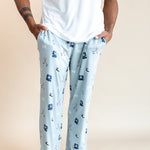 Modal wearing Men's Lounge Pants in Vintage Hockey print under a white T-shirt on a beige background
::: Model is 6'2" wearing size L ///