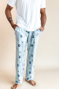 Modal wearing Men's Lounge Pants in Vintage Hockey print under a white T-shirt on a beige background