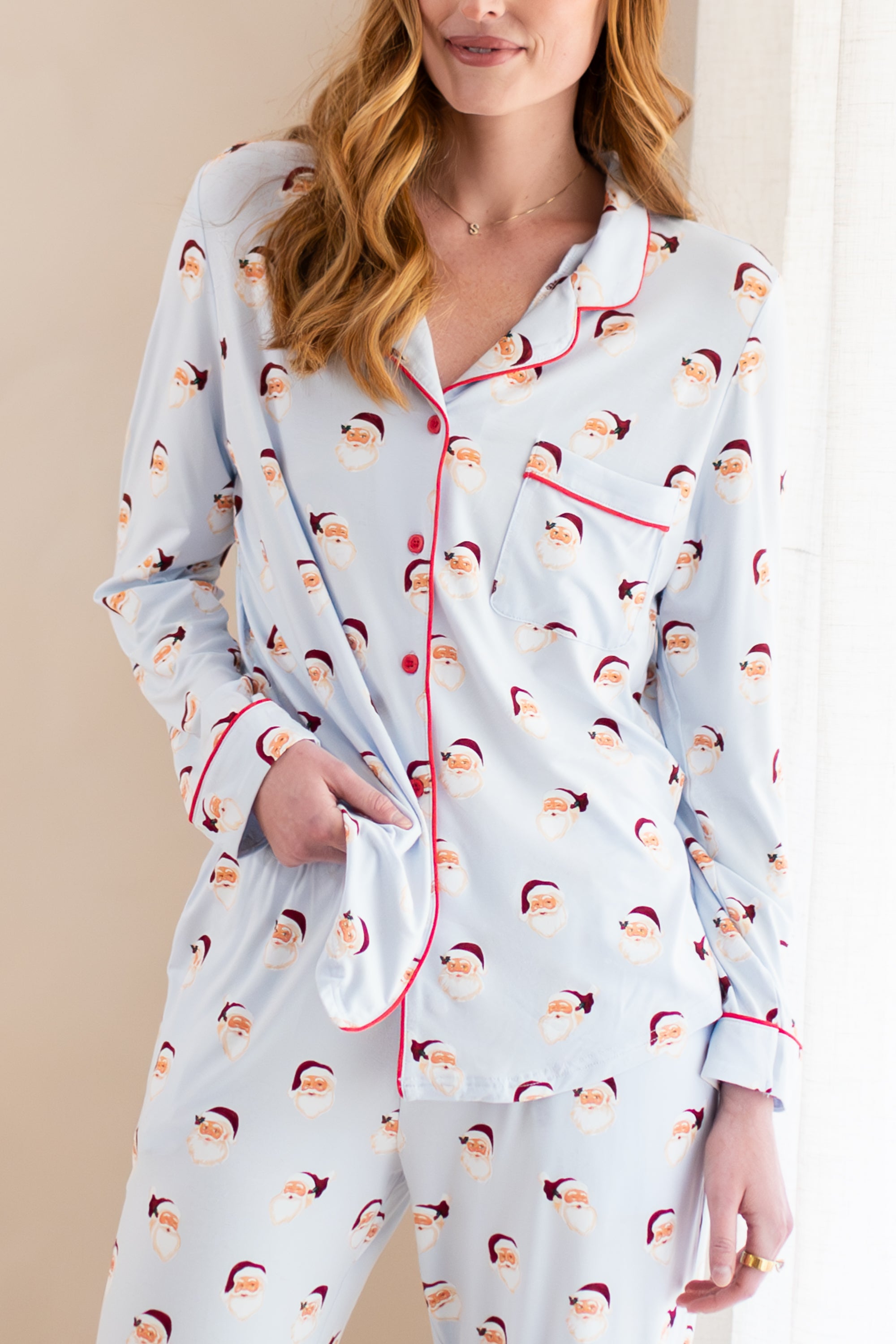 Woman wearing a pajama set with Santa Claus pattern