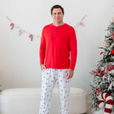 Model waring the Men's Long Sleeve Henley Top in Cardinal paired with the Mens Lounge Pants in Vintage Santa