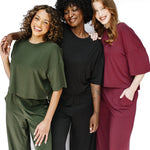 Models wearing the Women's Short Sleeve Tees and matching wide leg pants in Fir, Midnight and Burgundy