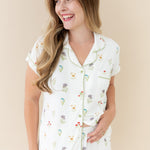 Woman smiling looking off to side wearing  Women’s Short Sleeve Pajama Set in Wildflower