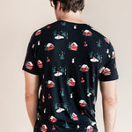 Back of a man looking down wearing crew neck tee in winter wonderland