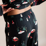 Womans back half raising her top up in winter wonderland long sleeve pajama set