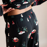 Womans back half raising her top up in winter wonderland long sleeve pajama set