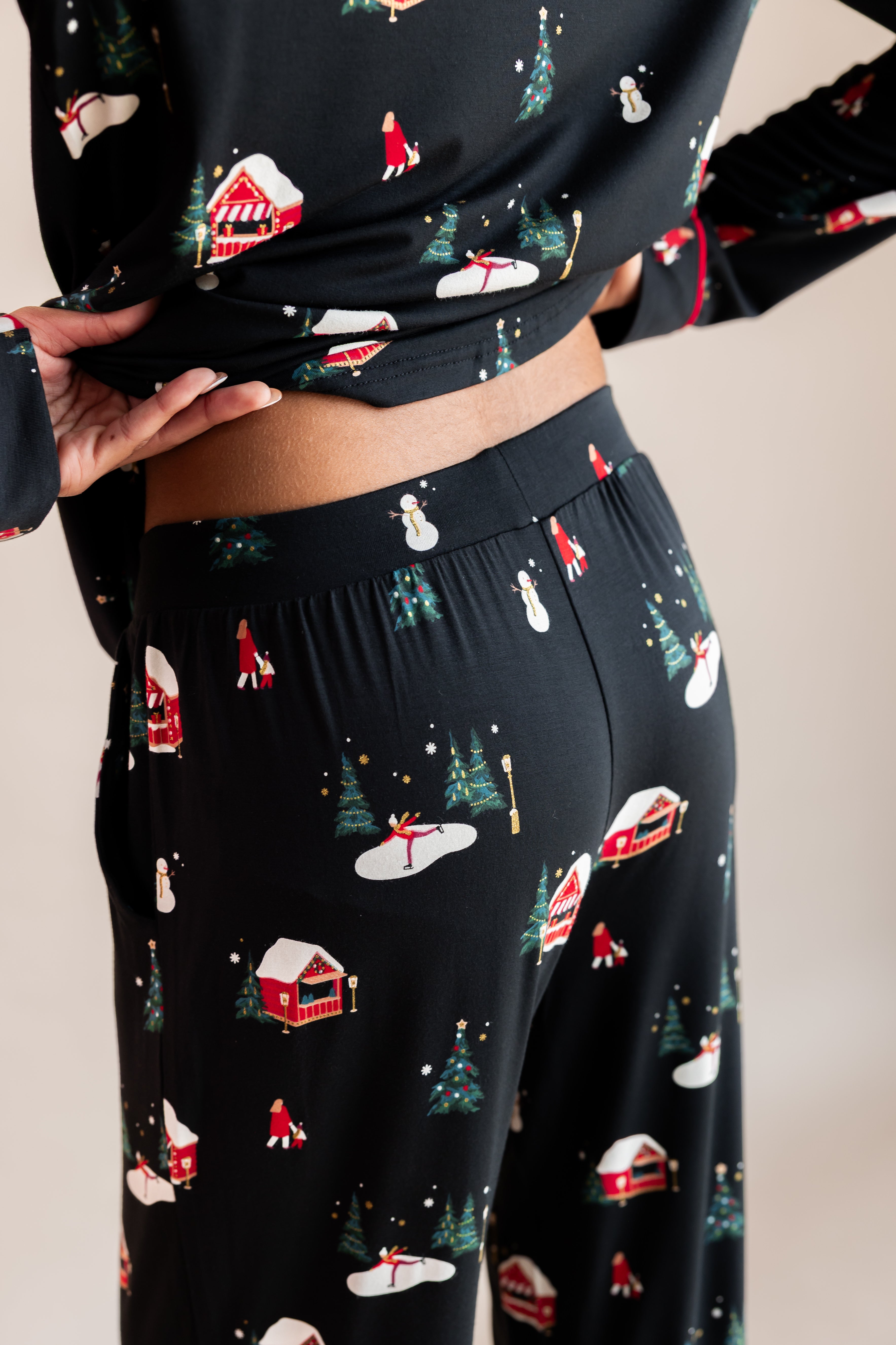 Womans back half raising her top up in winter wonderland long sleeve pajama set
