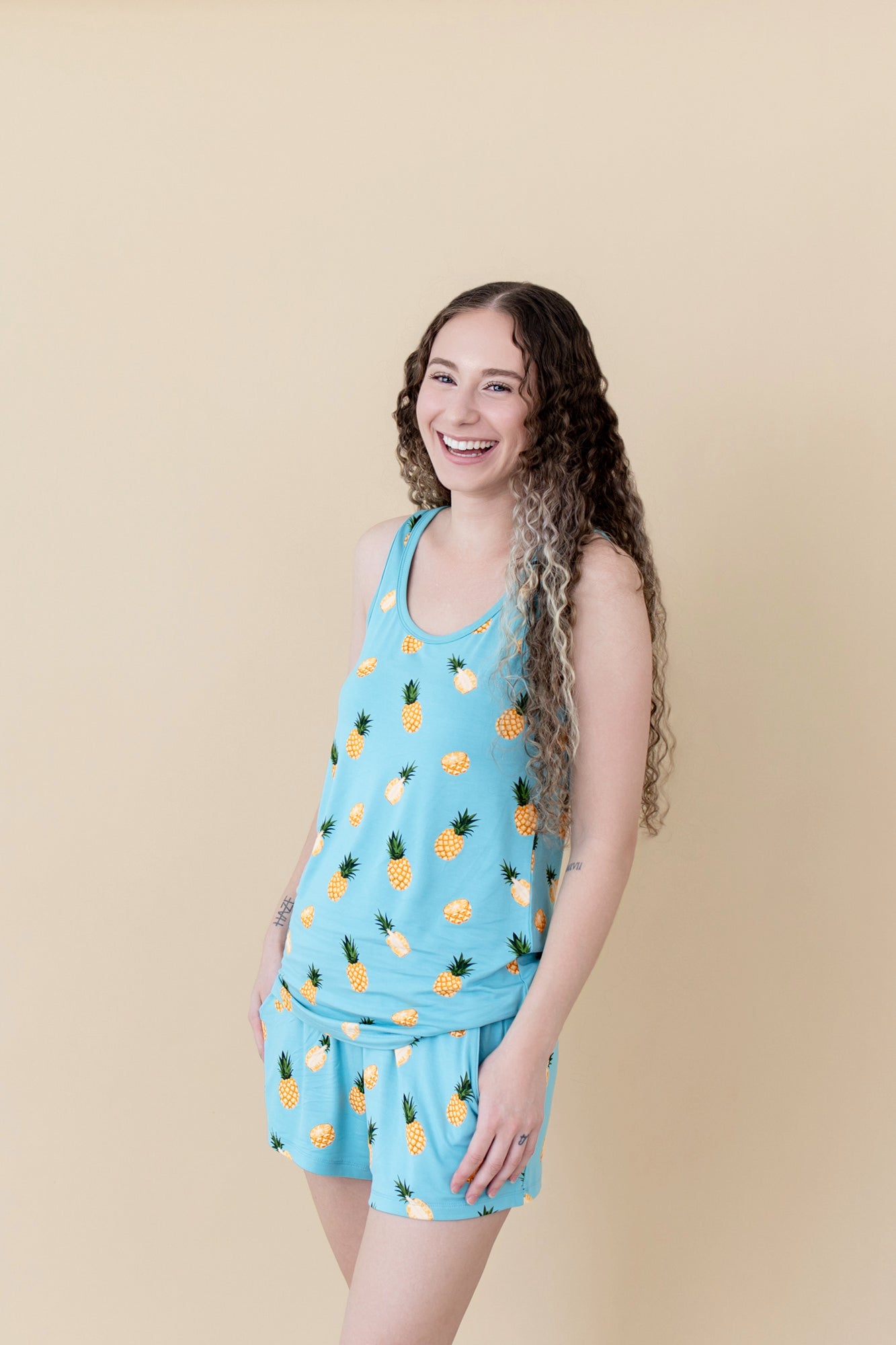 Woman laughing and wearing Women’s Tank Set in Pineapple
