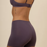 Model showcasing back side of women's Women's Boxer in Currant and back straps of matching bra 