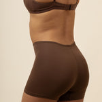 Model showcasing the back side of the Women's Boxer in Toffee and straps of the matching bra
