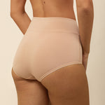 Beige high-waisted underwear on a neutral background