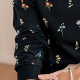 Close up of the sleeve of the Women's Sweatshirt in Midnight Wildflower