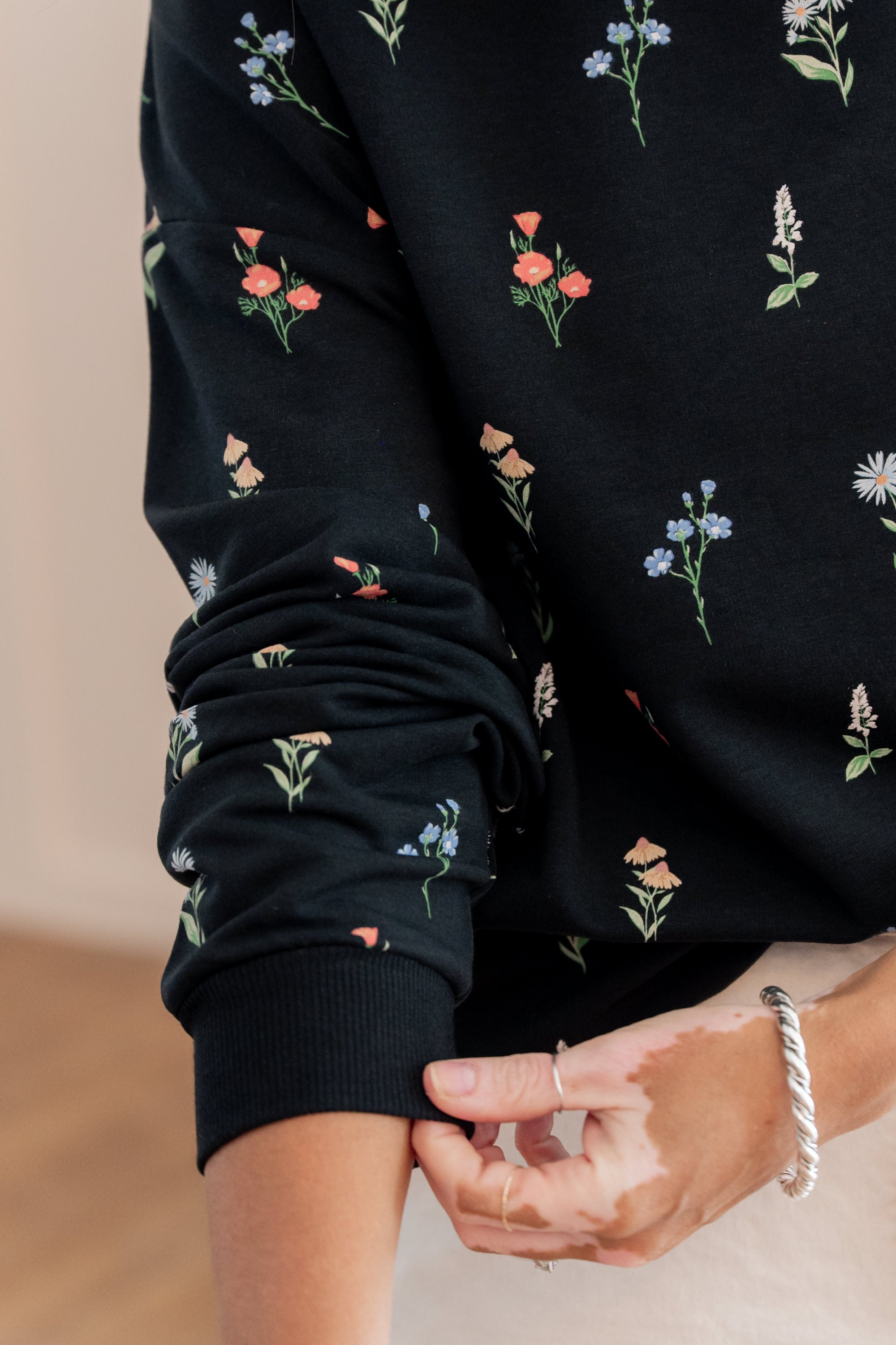 Close up of the sleeve of the Women's Sweatshirt in Midnight Wildflower