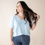 Smiling model looking to the side while wearing the Women's V Neck in Breeze denim ::: Model is 5'6" wearing size M ///