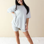 Smiling female model wearing the Women’s Biker Short Set in Oat