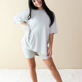 Smiling female model wearing the Women’s Biker Short Set in Oat